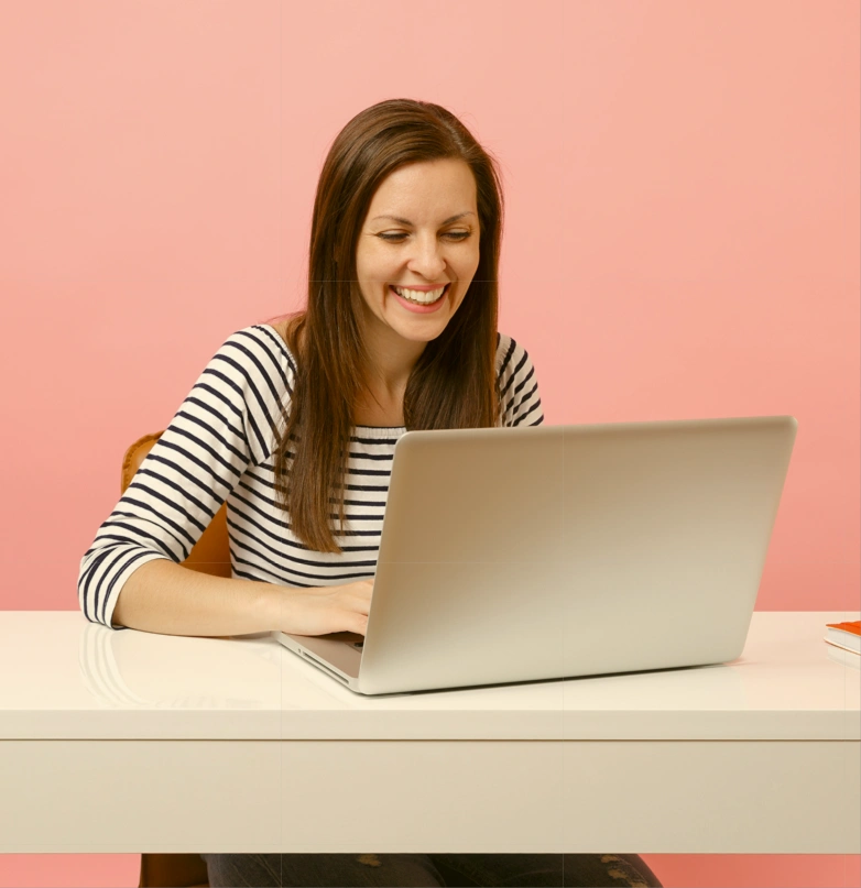 Woman working happily on her computer
